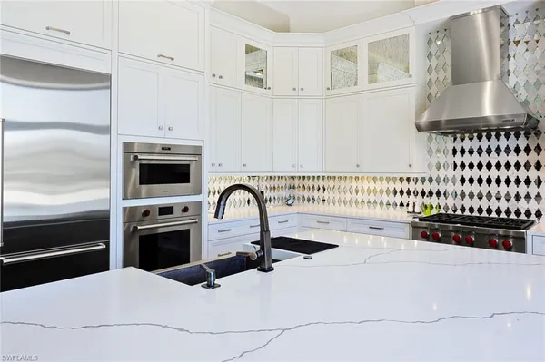 a kitchen with a refrigerator and a stove