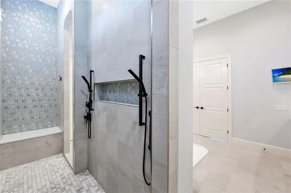 a bathroom with a granite countertop shower