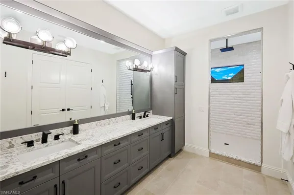 a bathroom with a double vanity sink and a mirror