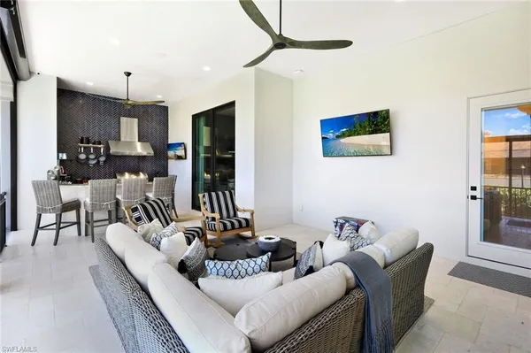 a living room with furniture and a chandelier