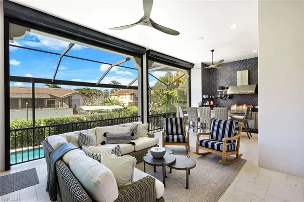 a living room with furniture and a floor to ceiling window