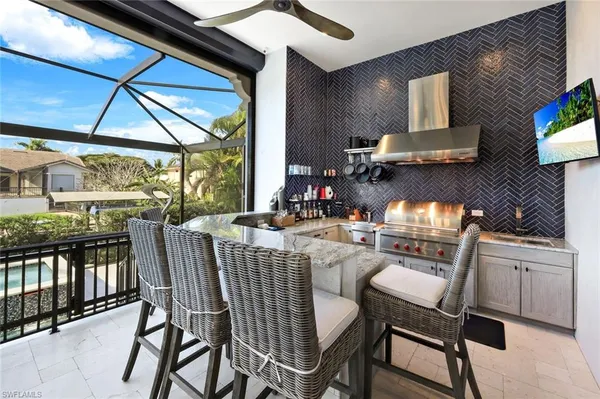 a kitchen with stainless steel appliances granite countertop a stove a sink and a dining table with granite countertops