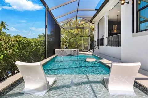 a view of a patio with table and chairs and potted plants