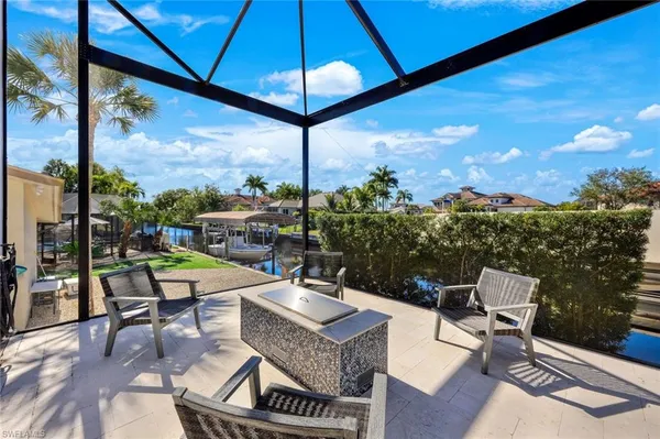 a view of a patio with a table and chairs under an umbrella