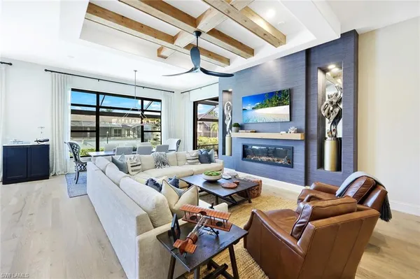 a living room with fireplace furniture and a large window