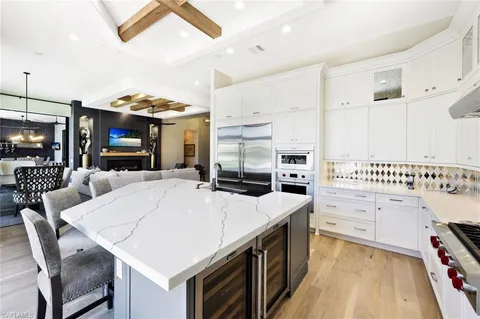 a large kitchen with a table and chairs