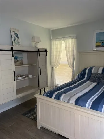 a room with a bed and a large window