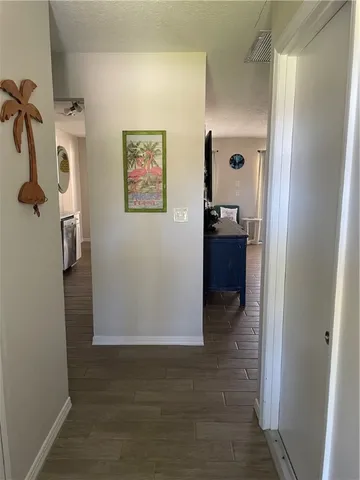 a view of a hallway with a furniture and closet area