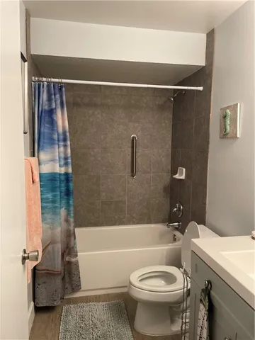 a bathroom with a toilet a sink and bathtub