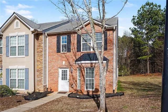 a backyard of a house with barbeque oven table and chairs