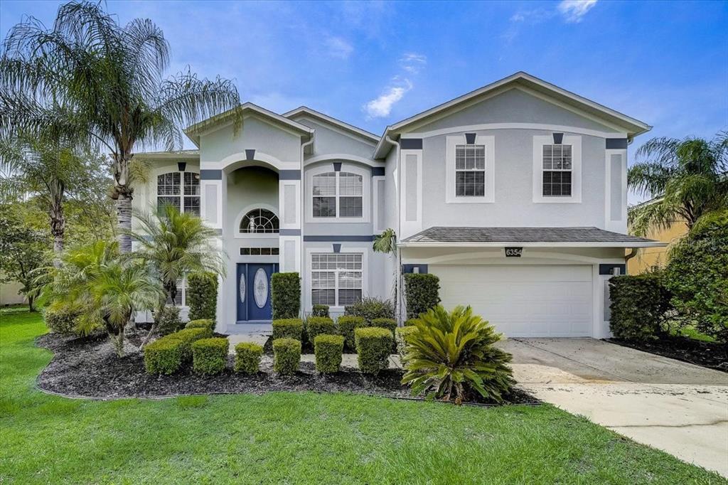 6354 Rolden Court Mount Dora, FL 32757 - Photo 1 of 1 a front view of a house with a garden