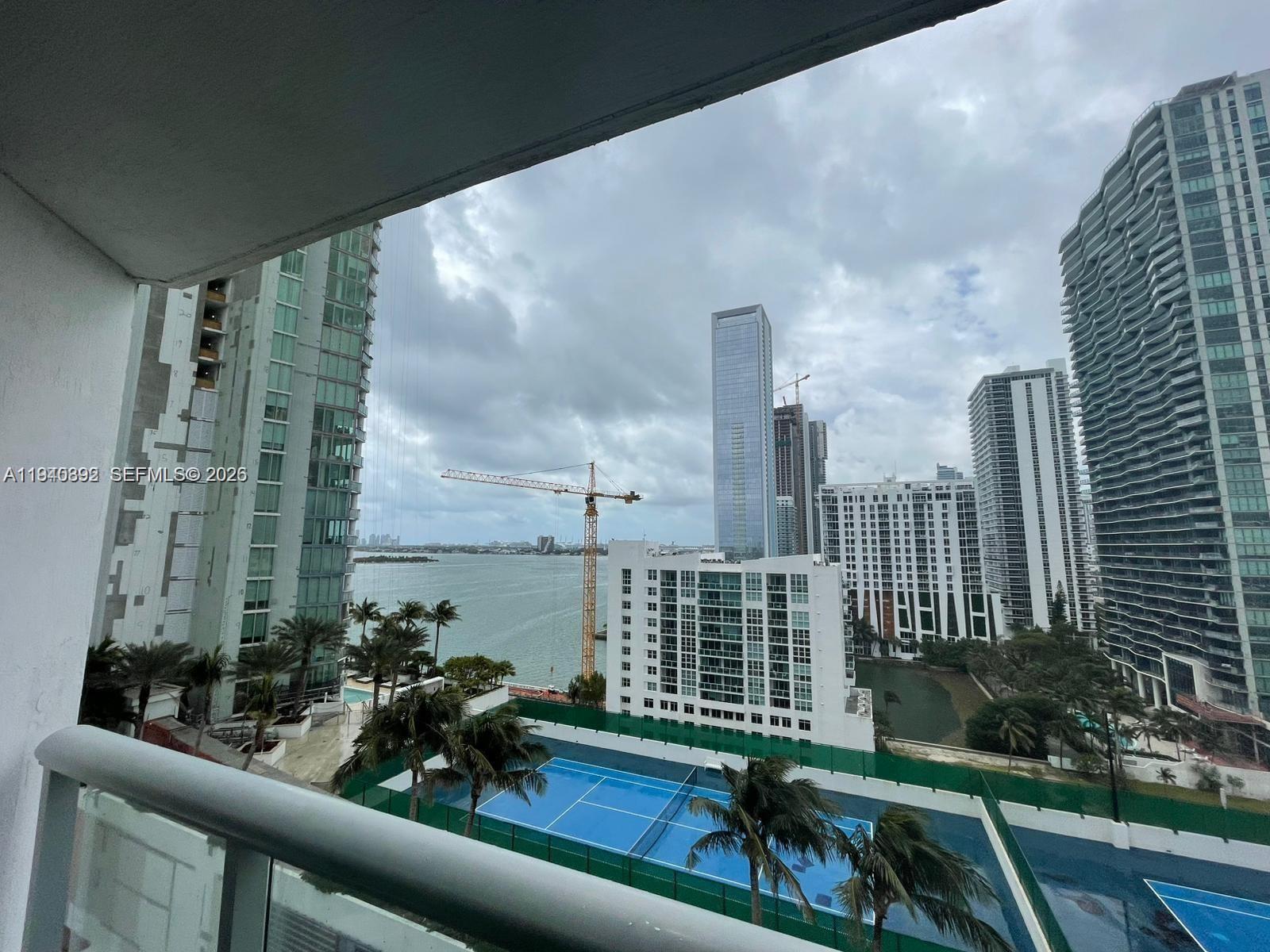 480 Northeast 30th Street, Unit 1403 Miami, FL 33137 - Photo 15 of 30 a view of a balcony with chairs and wooden fence
