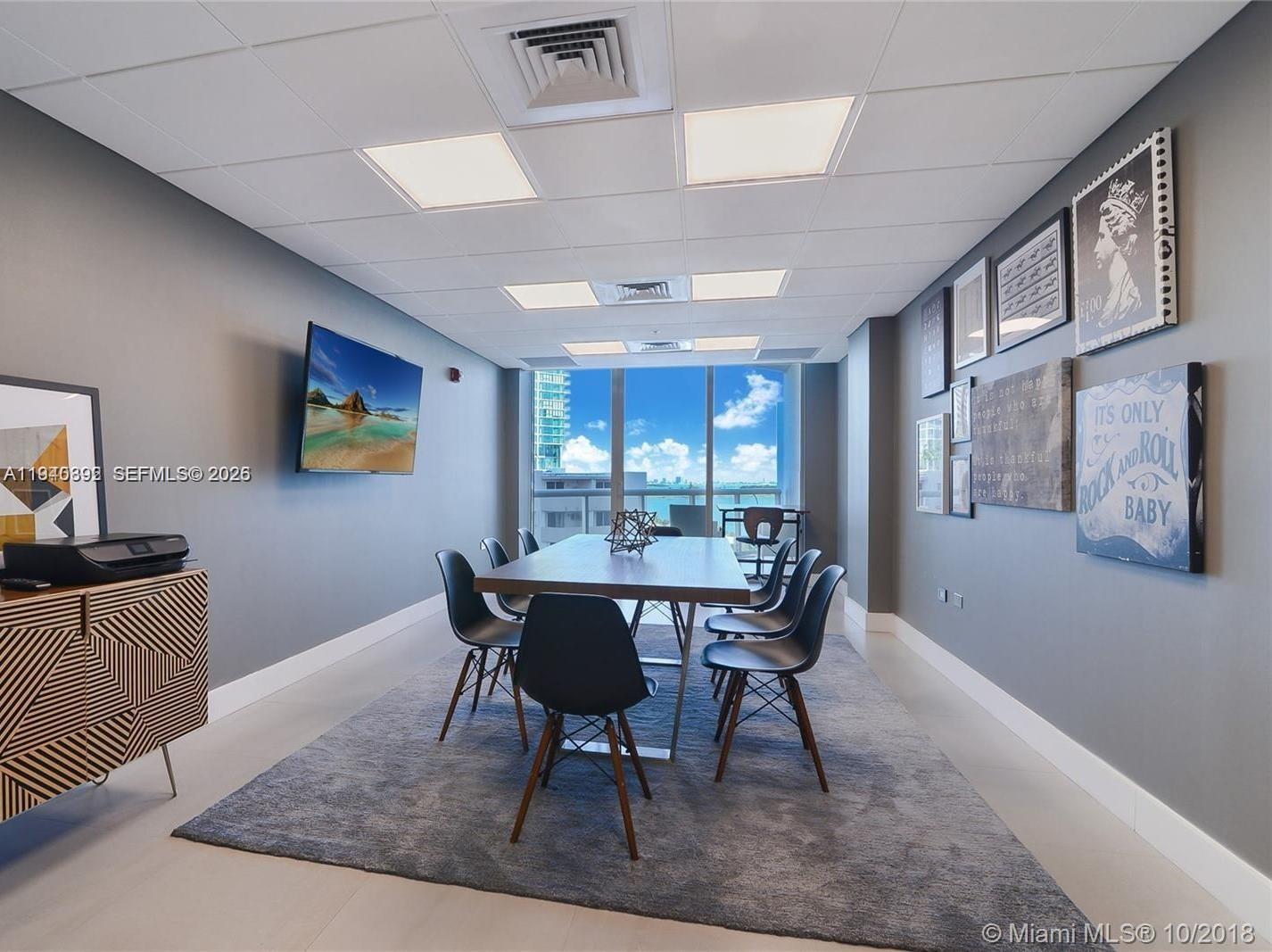 480 Northeast 30th Street, Unit 1403 Miami, FL 33137 - Photo 19 of 30 a view of a dining room with furniture window and wooden floor
