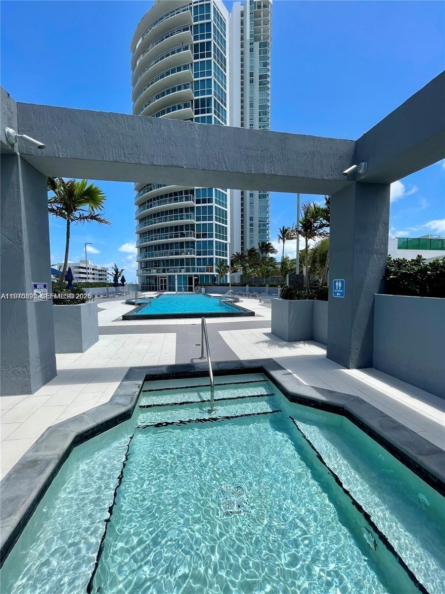 480 Northeast 30th Street, Unit 1403 Miami, FL 33137 - Photo 20 of 30 a view of a house with backyard and sitting area