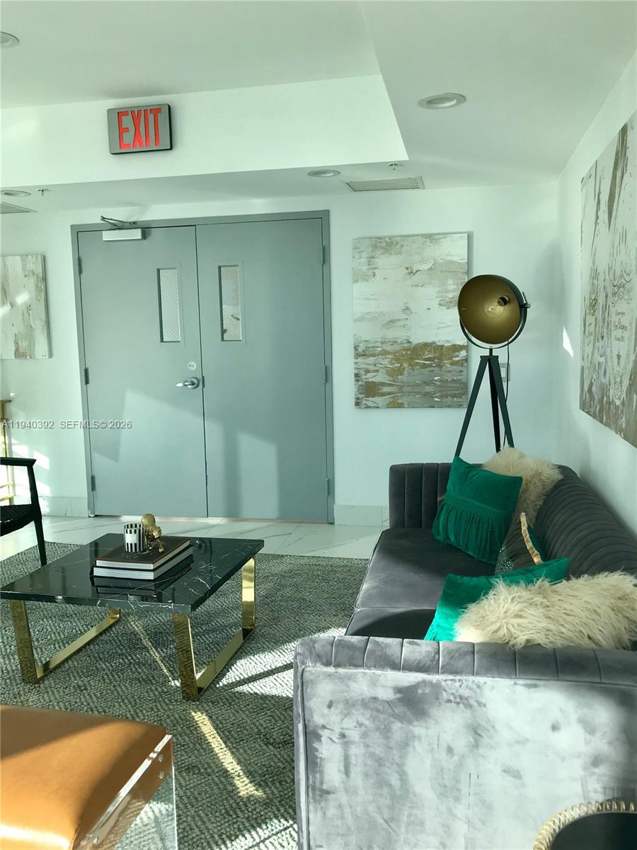 480 Northeast 30th Street, Unit 1403 Miami, FL 33137 - Photo 24 of 30 a living room with a couch and a table