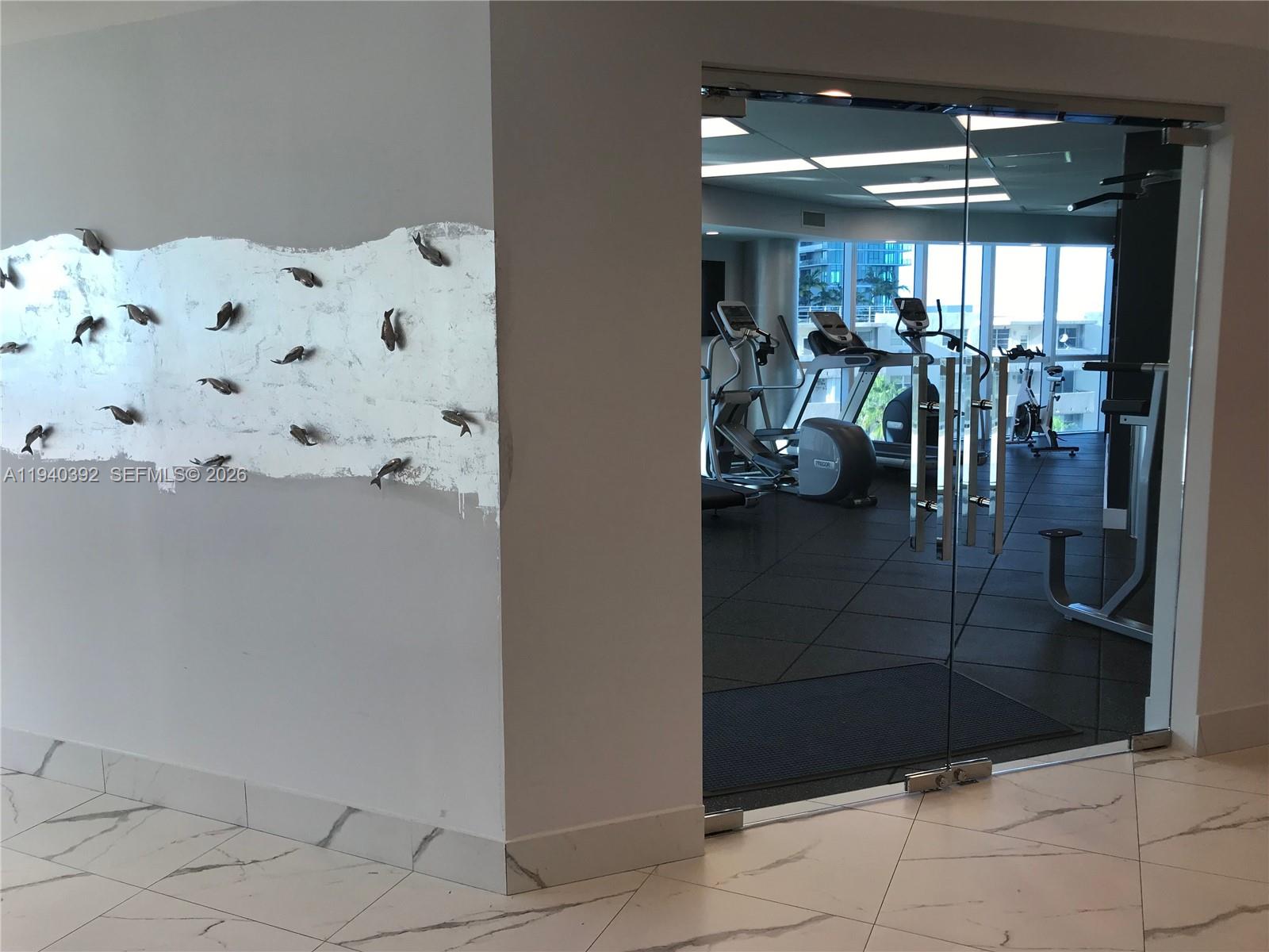 480 Northeast 30th Street, Unit 1403 Miami, FL 33137 - Photo 28 of 30 a room with lots of white furniture and shower