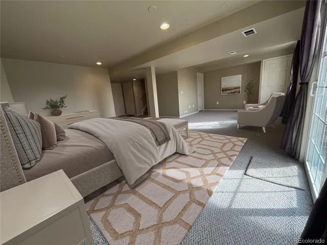 a living room with a couch and a walk in closet