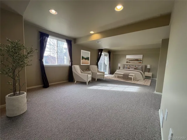 a living room with furniture and a potted plant