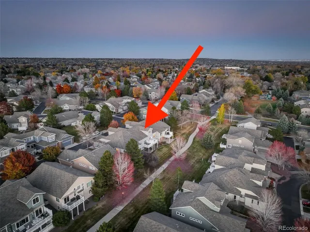 an aerial view of a houses with a yard