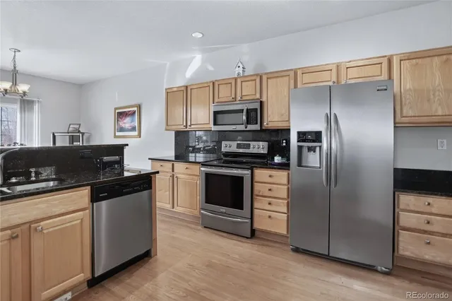 a kitchen with a sink stove and refrigerator