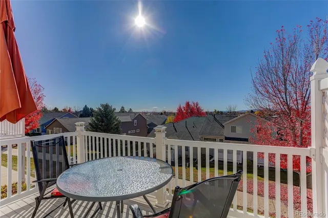 a view of a chairs and table in the balcony