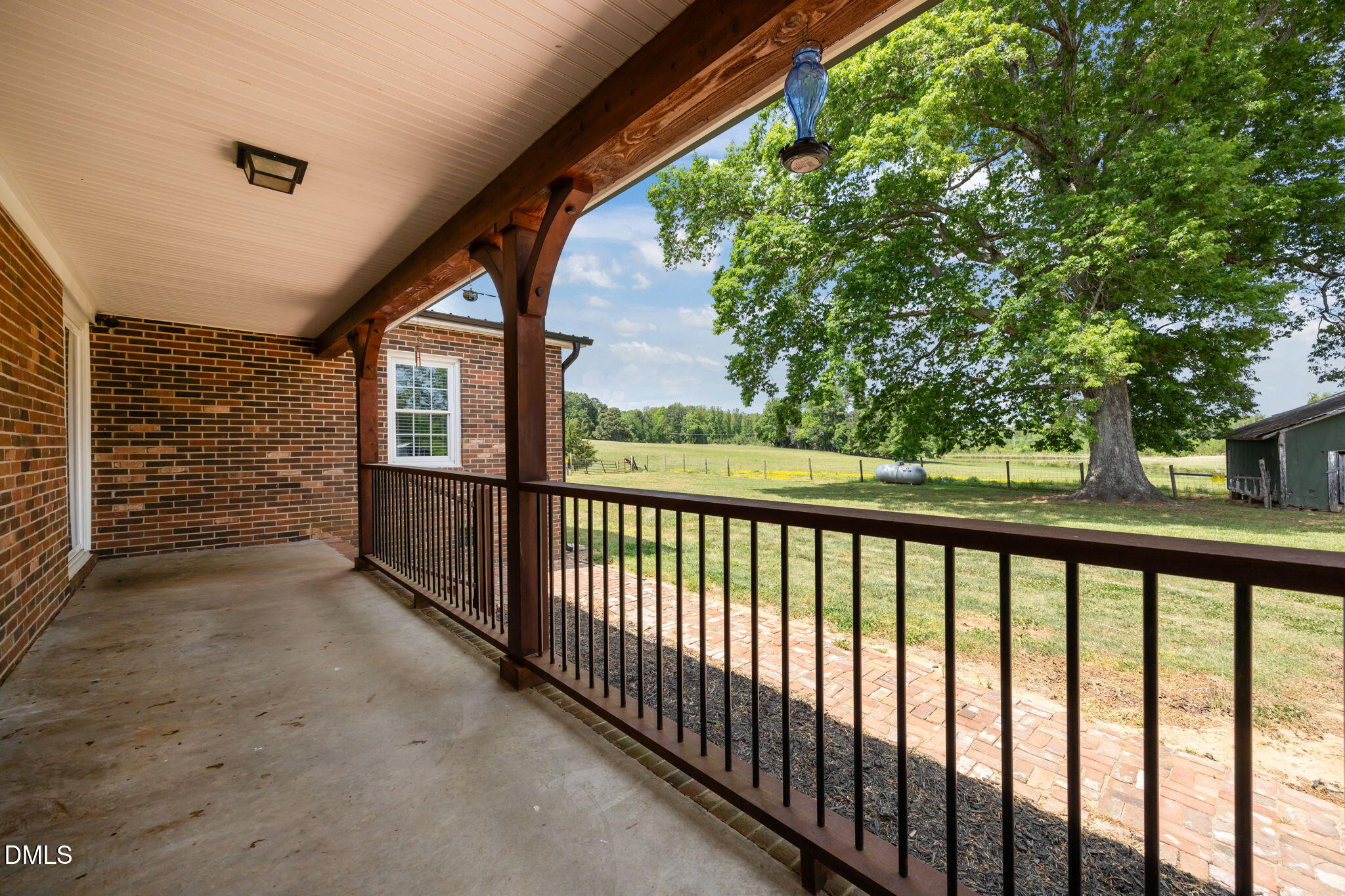 3611 Chewning Road Oxford, NC 27565 - Photo 16 of 45 a view of a porch with a floor to ceiling window and wooden fence