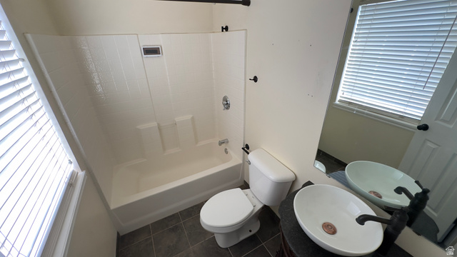 3547 East Golden Eagle Road Eagle Mountain, UT 84005 - Photo 20 of 47 Full bathroom with vanity, bathtub / shower combination, and dark tile patterned flooring