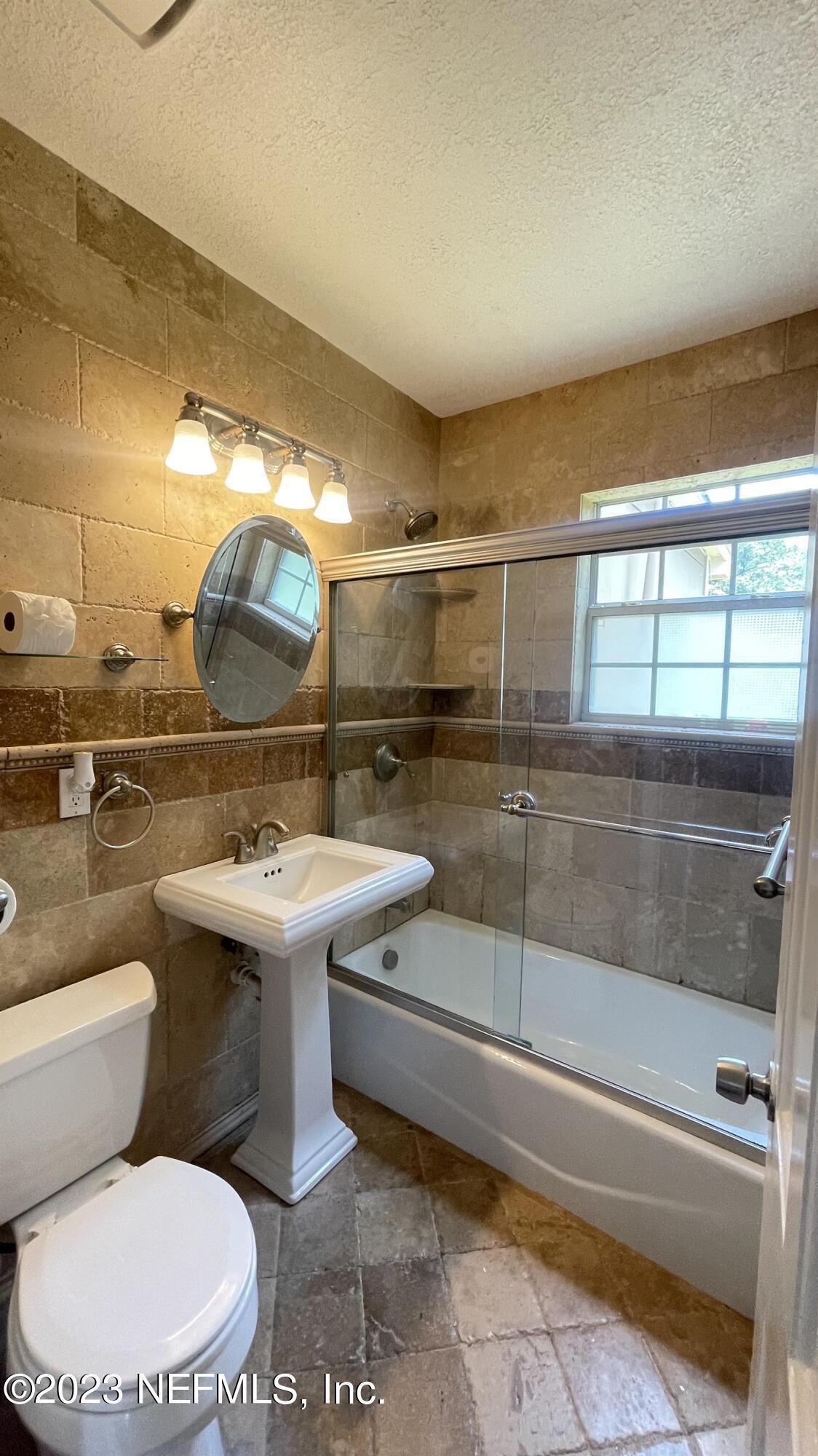 5228 Sunderland Road Jacksonville, FL 32210 - Photo 12 of 18 a bathroom with a toilet sink and mirror