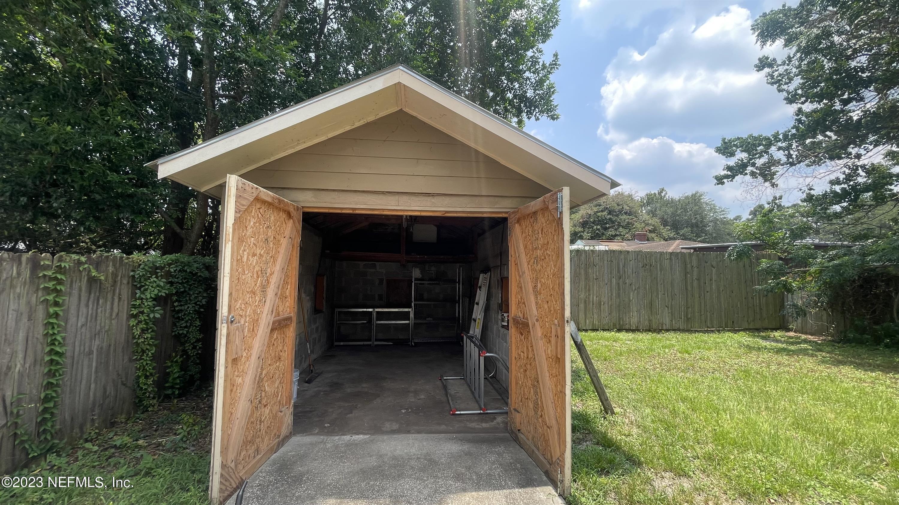 5228 Sunderland Road Jacksonville, FL 32210 - Photo 16 of 18 a front view of a house with garden