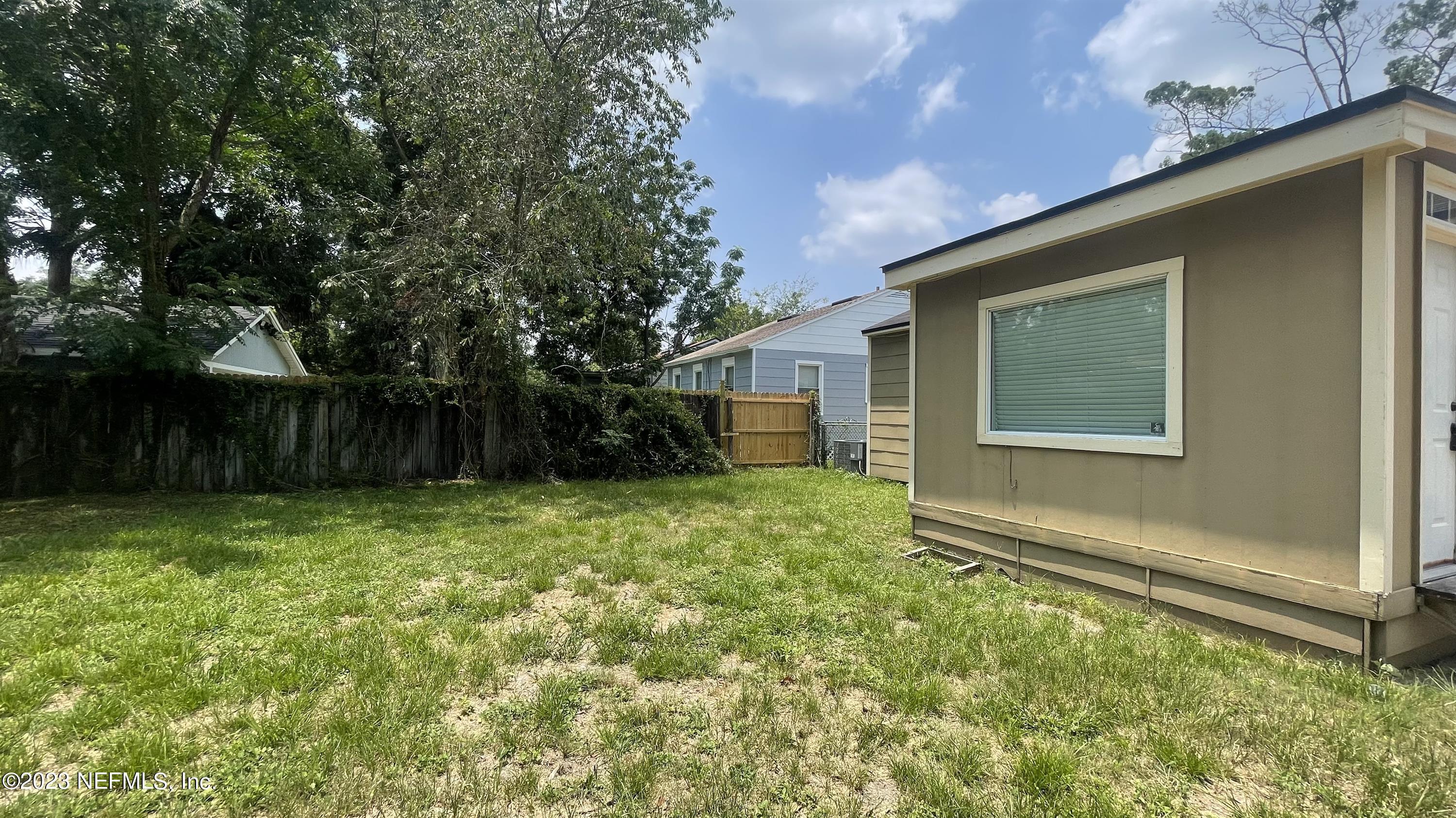 5228 Sunderland Road Jacksonville, FL 32210 - Photo 18 of 18 a view of a backyard with plants and large trees