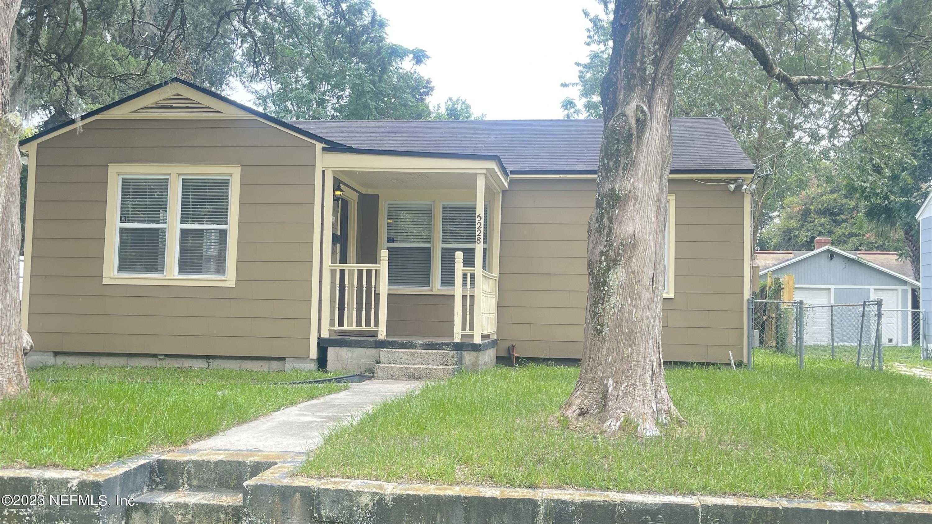 5228 Sunderland Road Jacksonville, FL 32210 - Photo 3 of 18 front view of a house with a yard