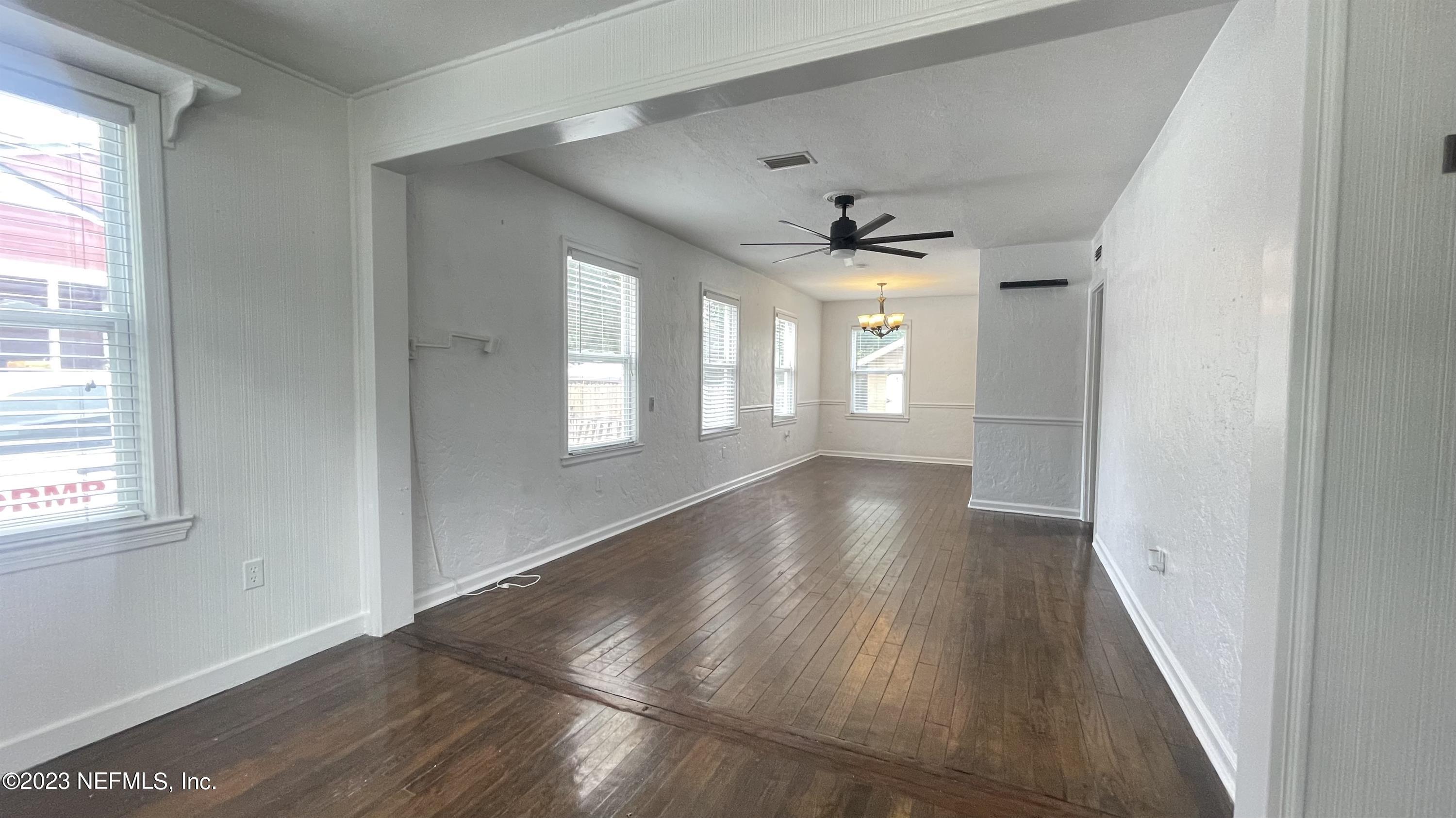 5228 Sunderland Road Jacksonville, FL 32210 - Photo 5 of 18 a view of an empty room with wooden floor and a window