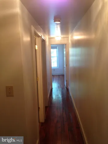 an empty room with wooden floor and closet