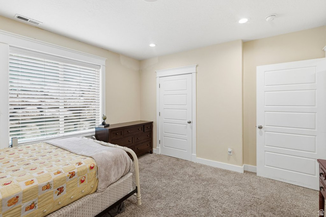 672 Perry Hollow Drive Mapleton, UT 84664 - Photo 60 of 106 Carpeted room featuring a large window with blinds, recessed lighting, and two panel doors