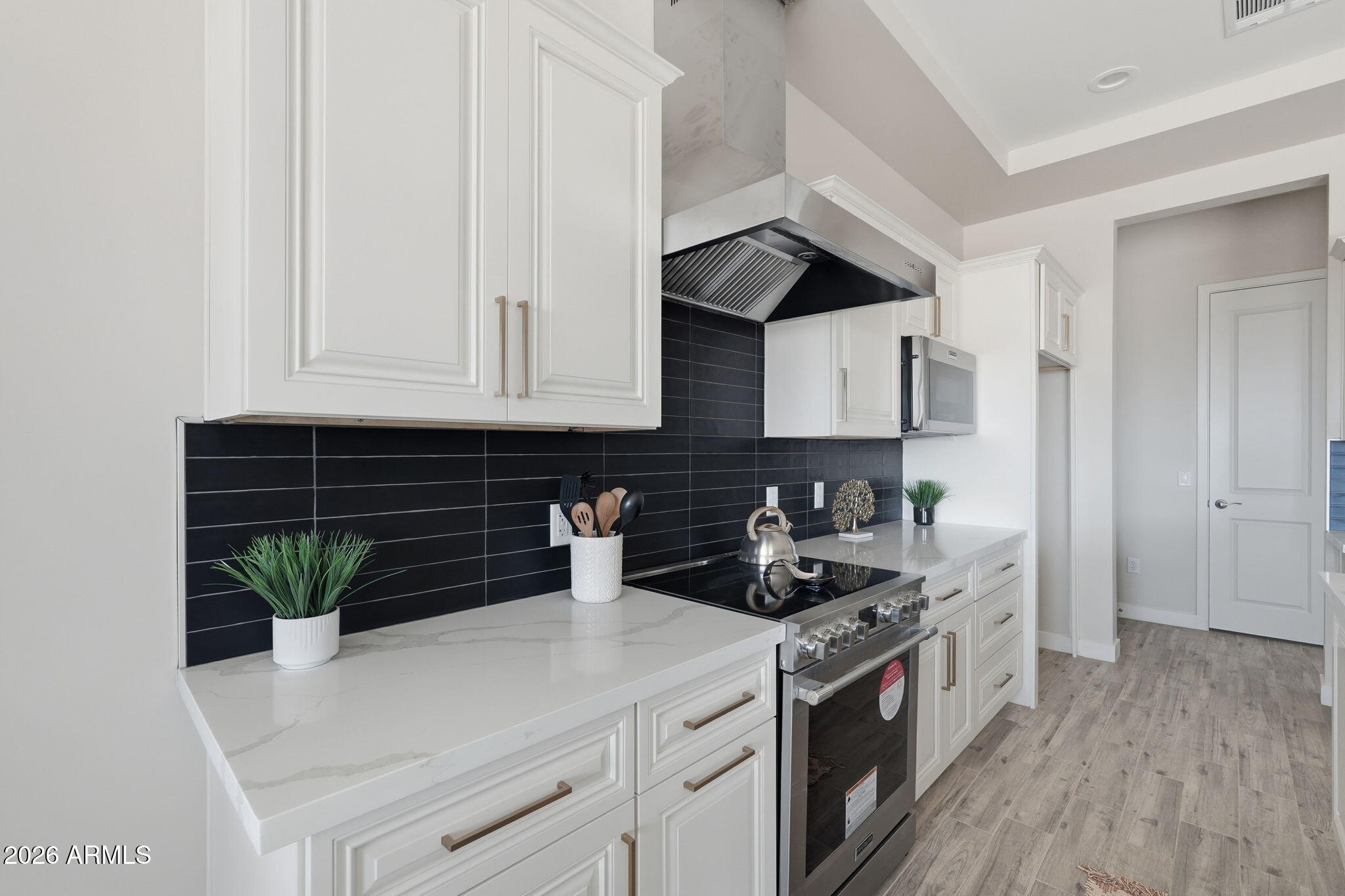 a kitchen with a sink a stove and cabinets