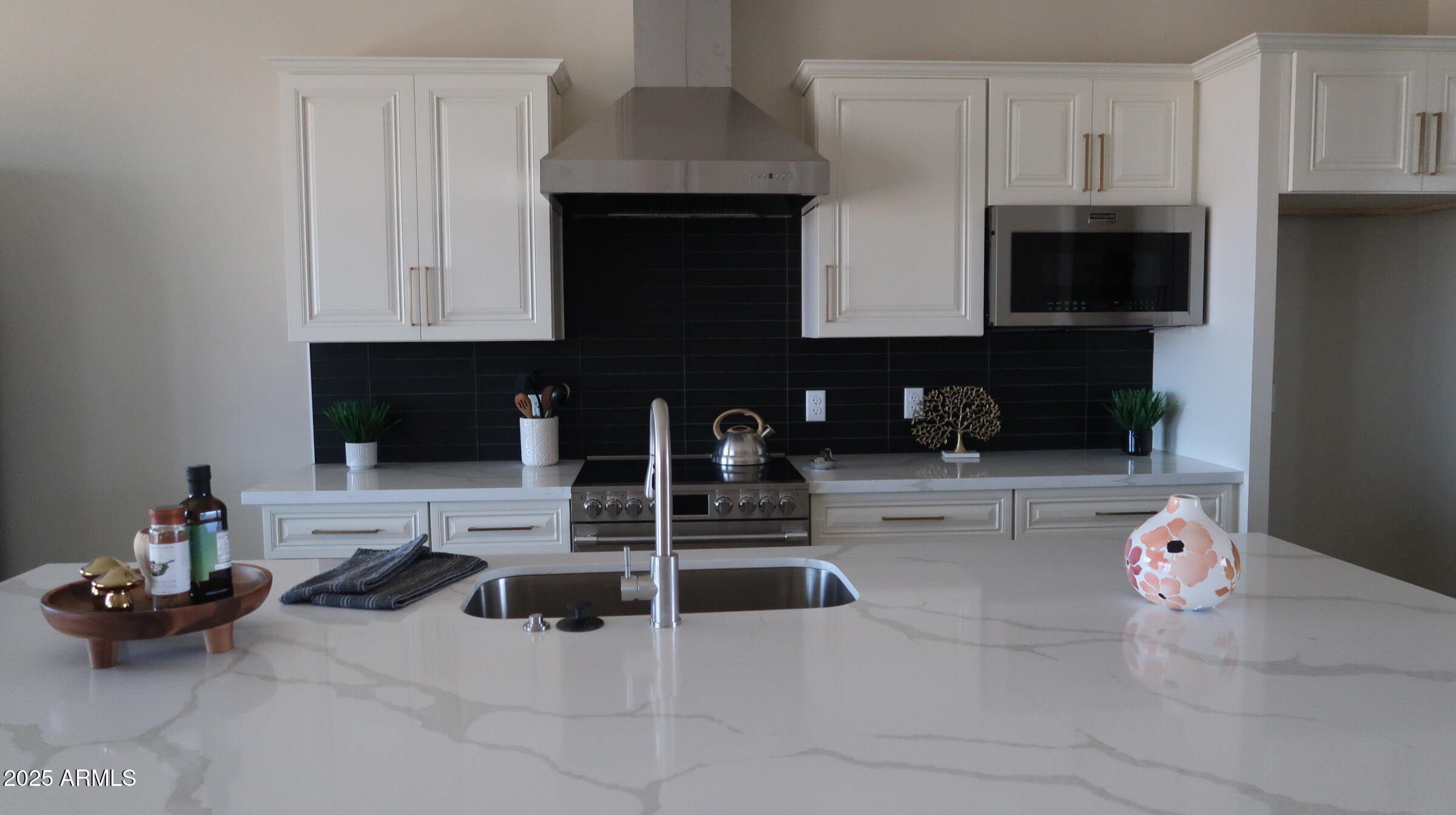 a kitchen with stainless steel appliances kitchen island granite countertop a sink and cabinets