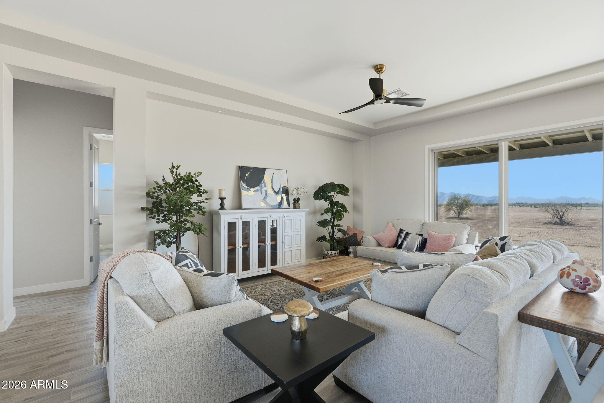 23131 West Skinner Road Wittmann, AZ 85361 - Photo 23 of 48 a living room with furniture a chandelier and a window