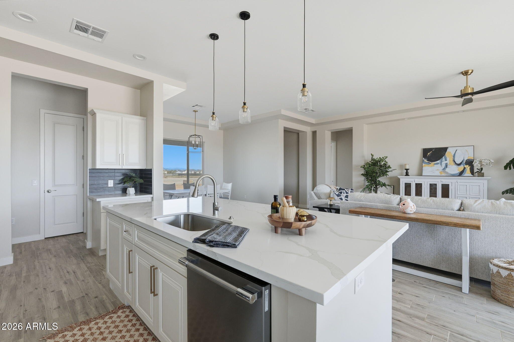 23131 West Skinner Road Wittmann, AZ 85361 - Photo 28 of 48 a kitchen with a sink a stove and cabinets