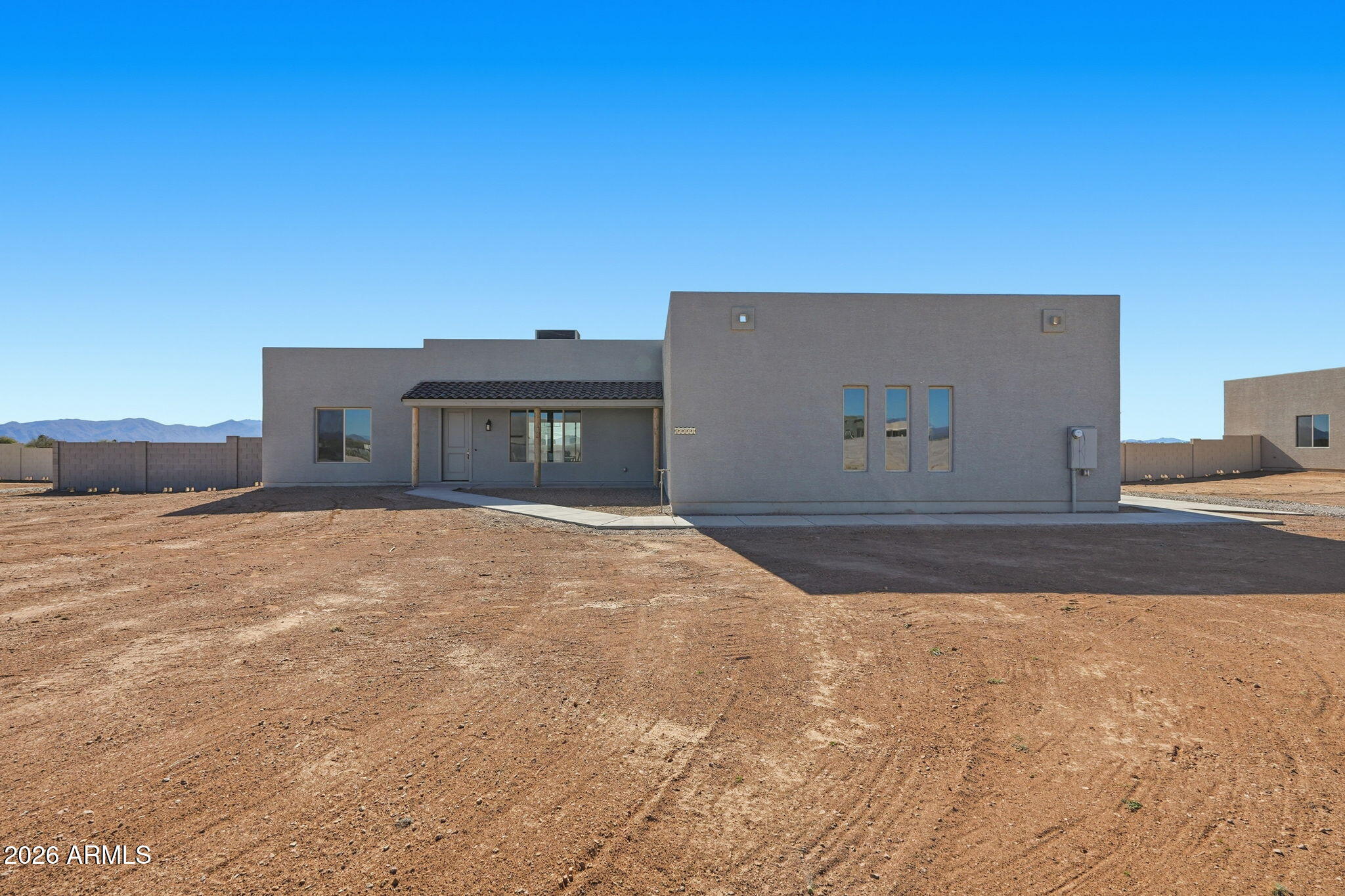 23131 West Skinner Road Wittmann, AZ 85361 - Photo 3 of 48 a front view of a house with a yard
