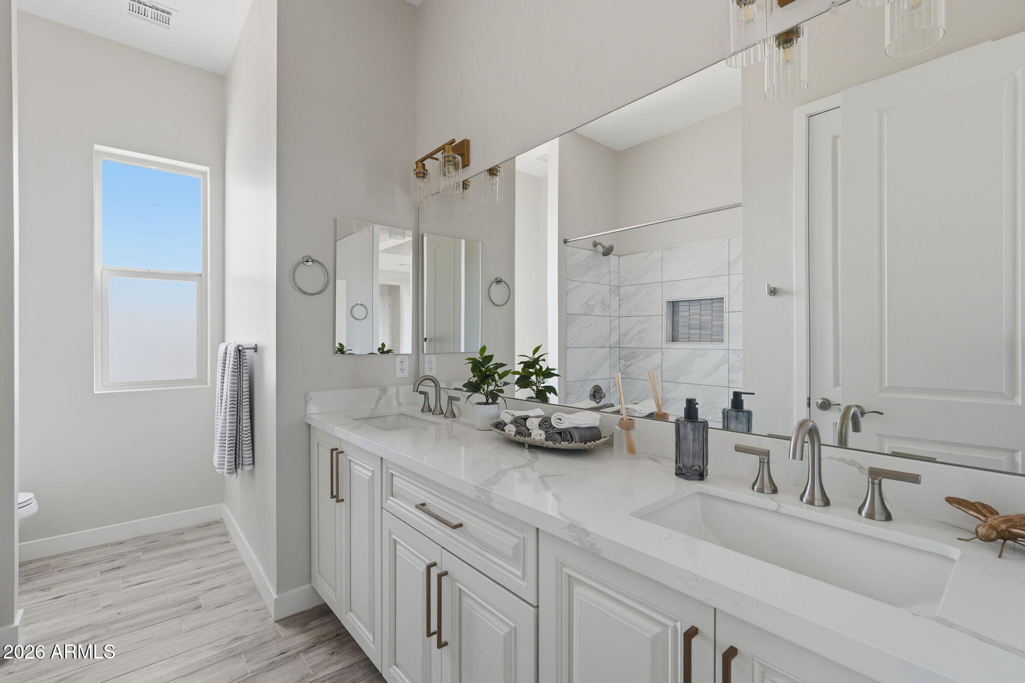 23131 West Skinner Road Wittmann, AZ 85361 - Photo 37 of 48 a bathroom with a double vanity sink and mirror