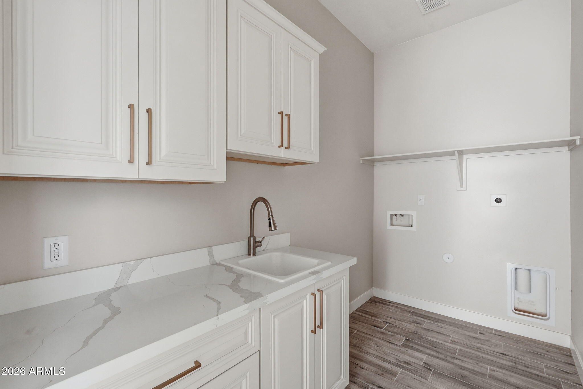 23131 West Skinner Road Wittmann, AZ 85361 - Photo 40 of 48 a kitchen with white cabinets and a sink