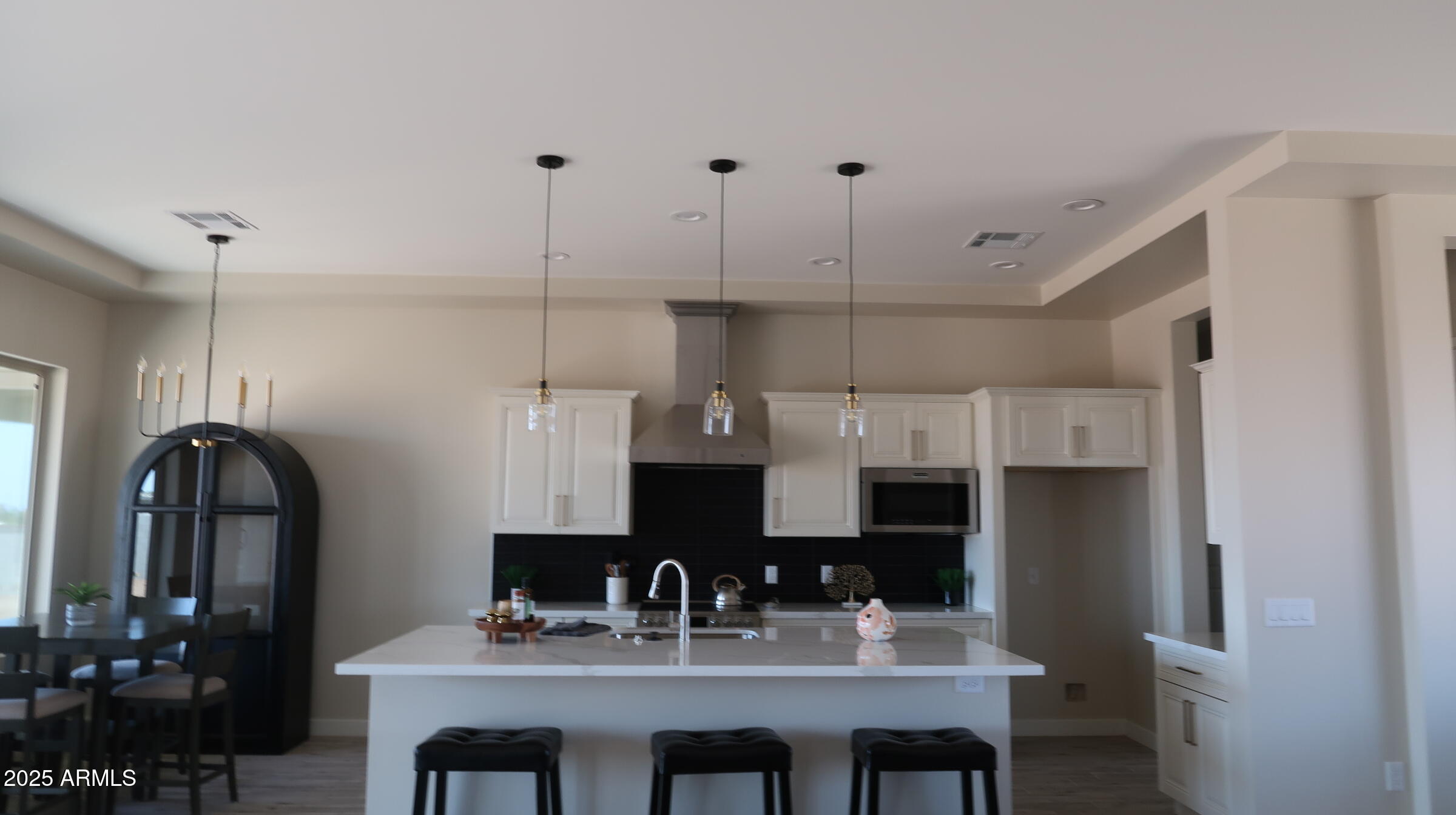 23131 West Skinner Road Wittmann, AZ 85361 - Photo 4 of 13 a kitchen with stainless steel appliances granite countertop a sink refrigerator and cabinets