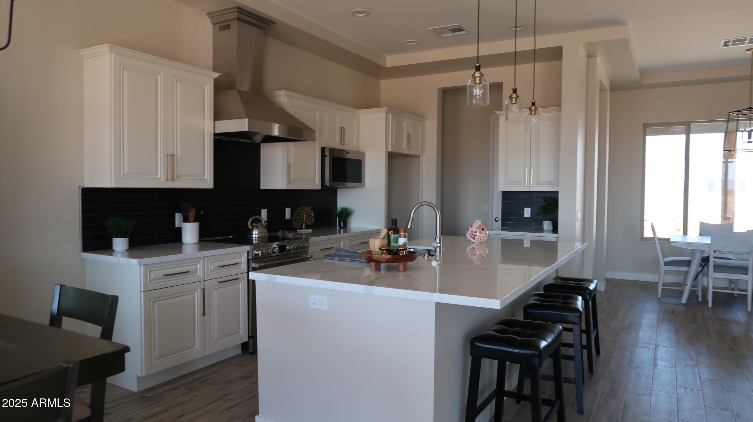 23131 West Skinner Road Wittmann, AZ 85361 - Photo 5 of 13 a kitchen with a sink stove and cabinets