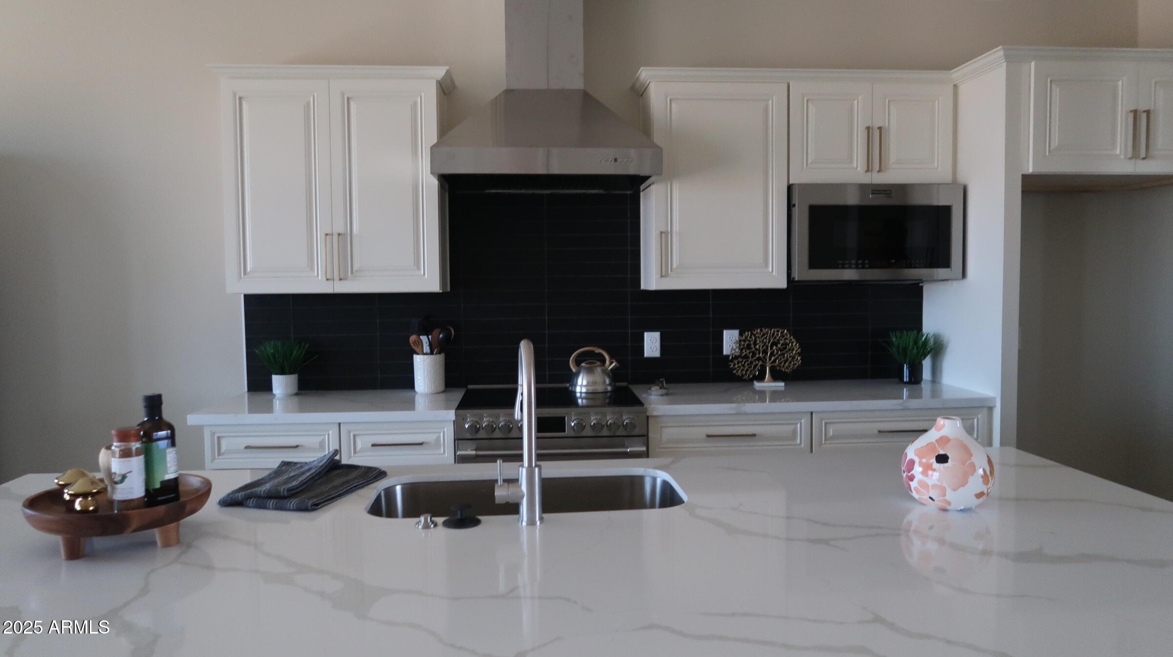 23131 West Skinner Road Wittmann, AZ 85361 - Photo 9 of 13 a kitchen with granite countertop a sink and a stove
