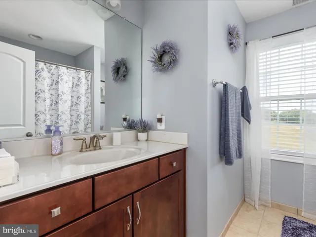 a spacious bedroom with a bed and ceiling fan