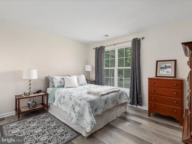 a spacious bathroom with a large tub sink and mirror