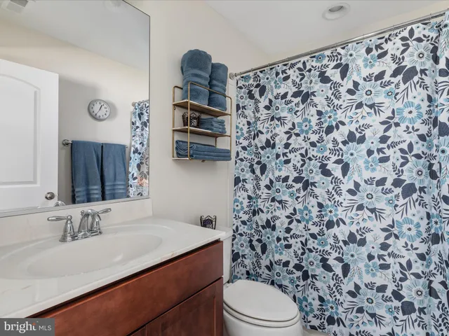 a utility room with lots of clutter and refrigerator