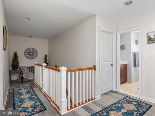 a view of a balcony with a floor to ceiling window and wooden fence