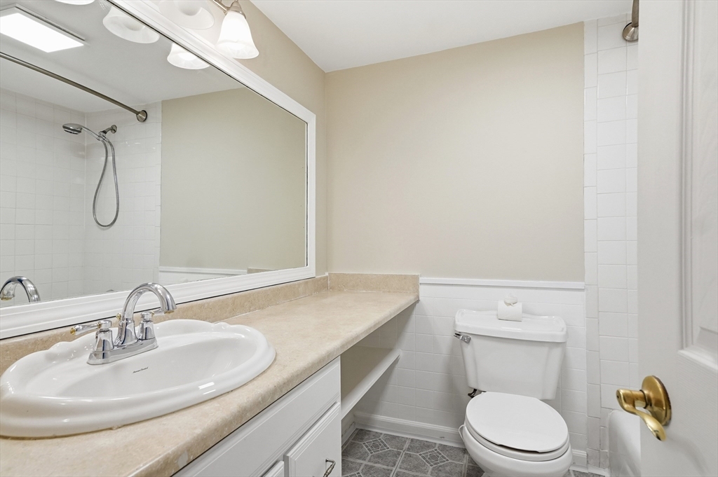 6 Adams Court, Unit 6 Amesbury, MA 01913 - Photo 13 of 22 a bathroom with a granite countertop sink toilet and a mirror