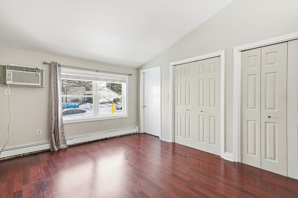 6 Adams Court, Unit 6 Amesbury, MA 01913 - Photo 19 of 22 an empty room with wooden floor and window